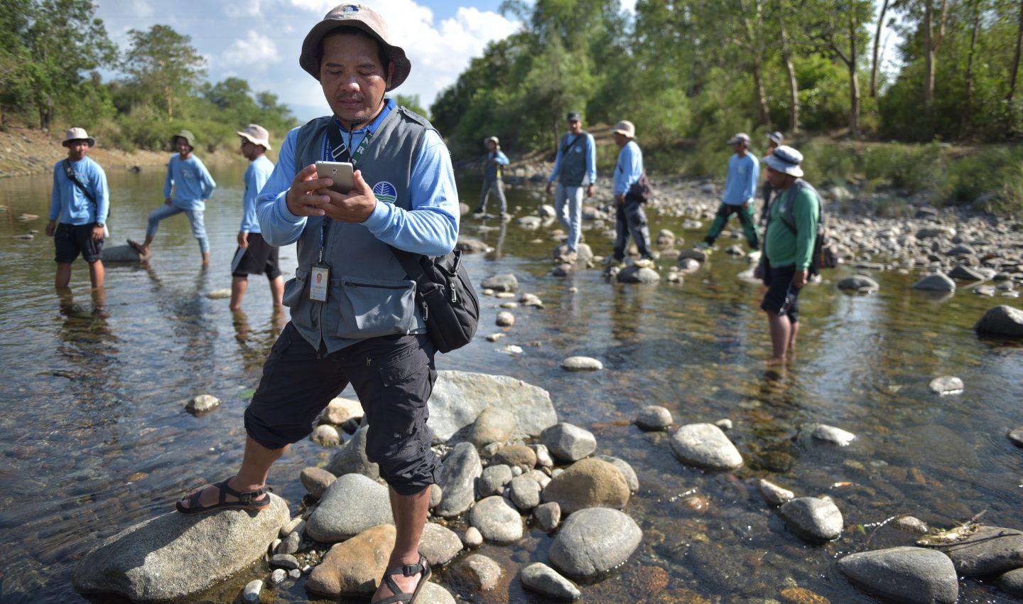Men stand in a river